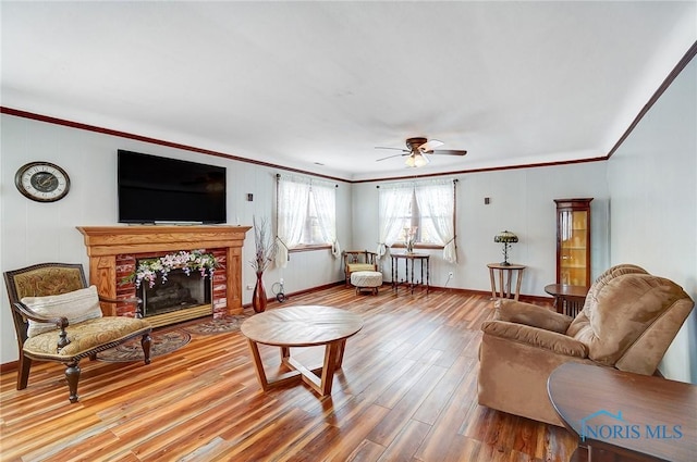 living room featuring crown molding, ceiling fan, and wood-type flooring