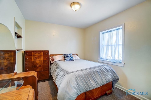 bedroom with dark colored carpet