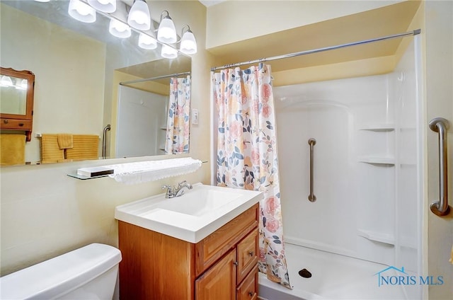 bathroom with toilet, vanity, and a shower with curtain