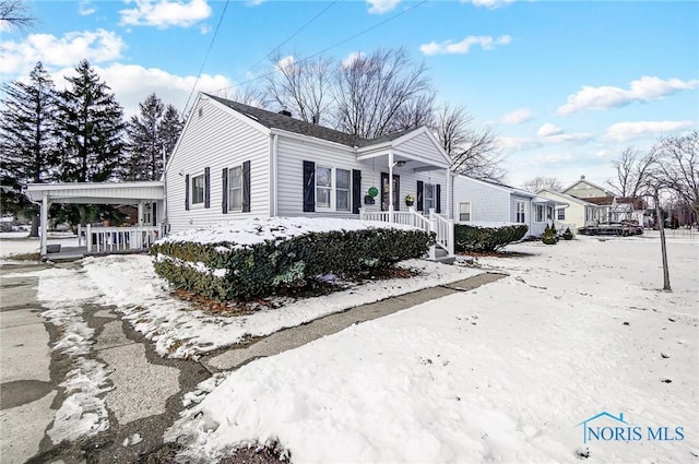 view of snowy exterior with covered porch