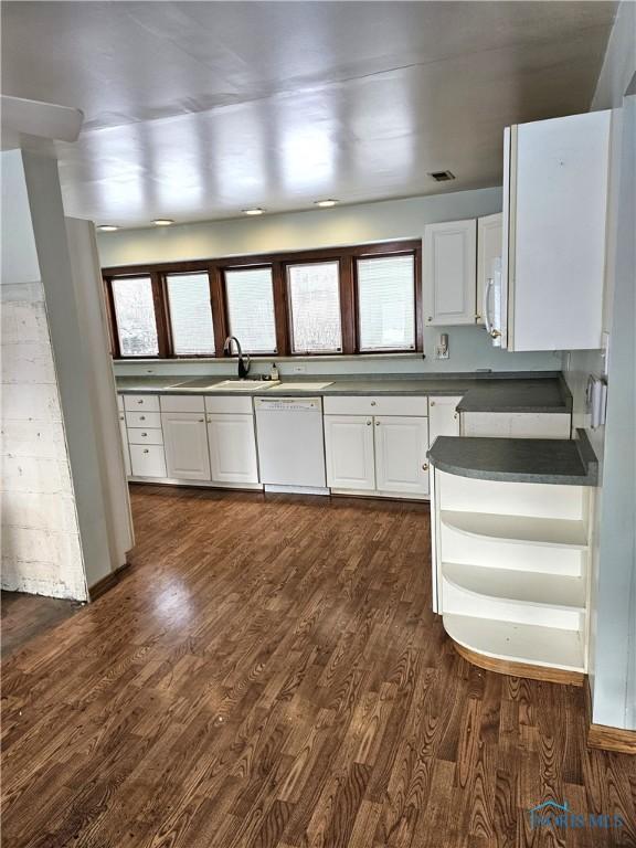 kitchen featuring dark hardwood / wood-style flooring, white appliances, and white cabinetry