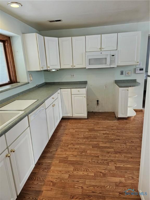 kitchen featuring white cabinetry, white appliances, and dark hardwood / wood-style flooring