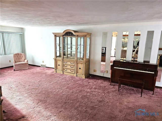 sitting room with ornamental molding and carpet flooring