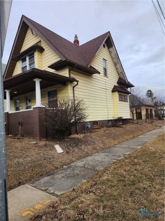 view of property exterior featuring covered porch