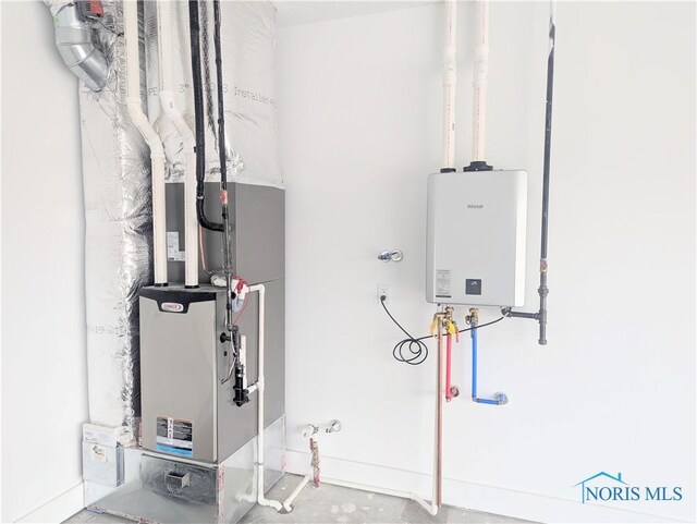 utility room featuring water heater and heating unit