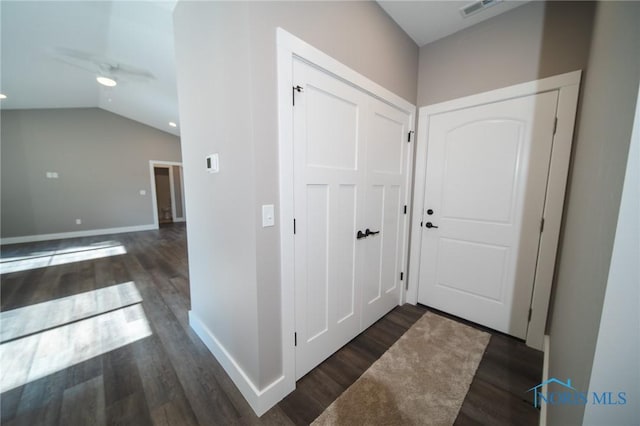 interior space featuring ceiling fan, dark hardwood / wood-style flooring, and vaulted ceiling