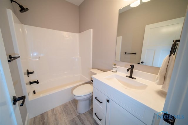 full bathroom with vanity, tub / shower combination, wood-type flooring, and toilet