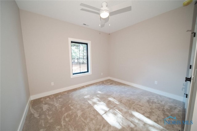 spare room featuring carpet flooring and ceiling fan