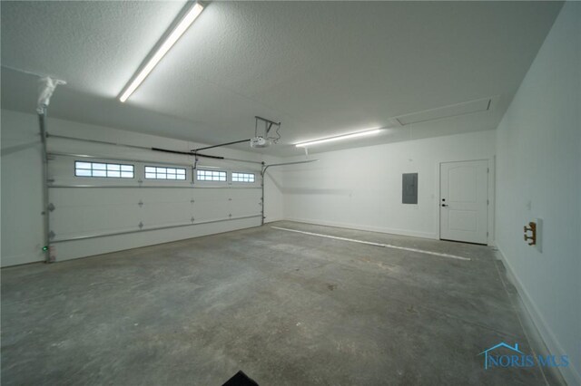 garage with a garage door opener and electric panel