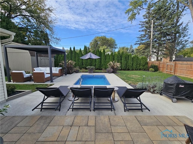 view of swimming pool featuring an outdoor hangout area, a patio area, and a lawn