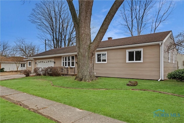 ranch-style house with a garage and a front yard