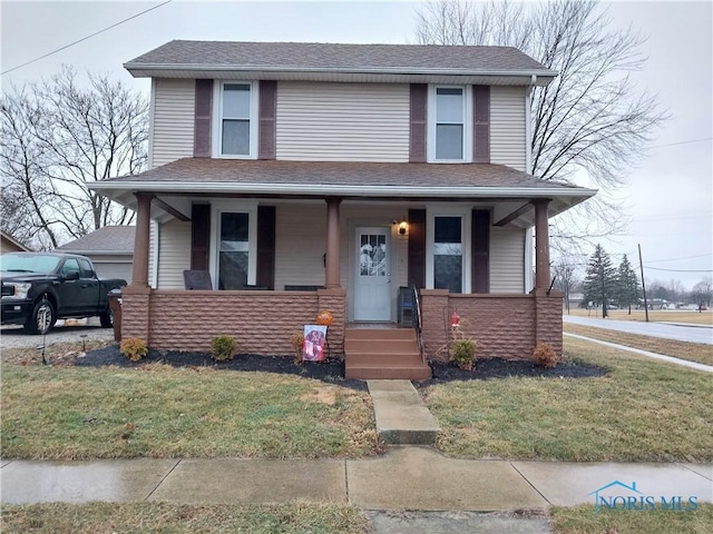 view of front of property with a front yard and a porch