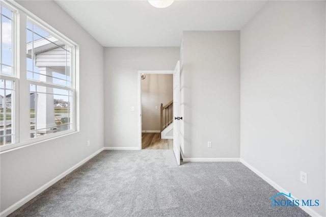 carpeted spare room with a wealth of natural light