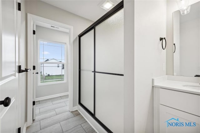 bathroom with vanity and an enclosed shower