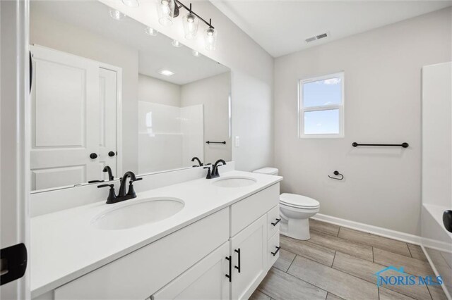 bathroom featuring vanity and toilet