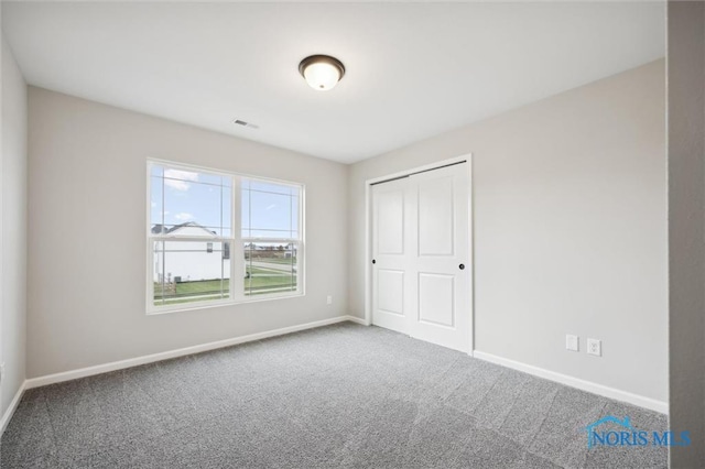 unfurnished bedroom with carpet floors and a closet