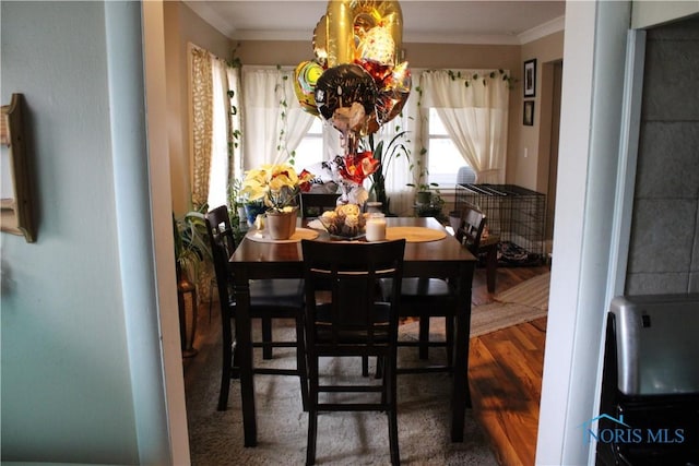 dining space with crown molding and a chandelier