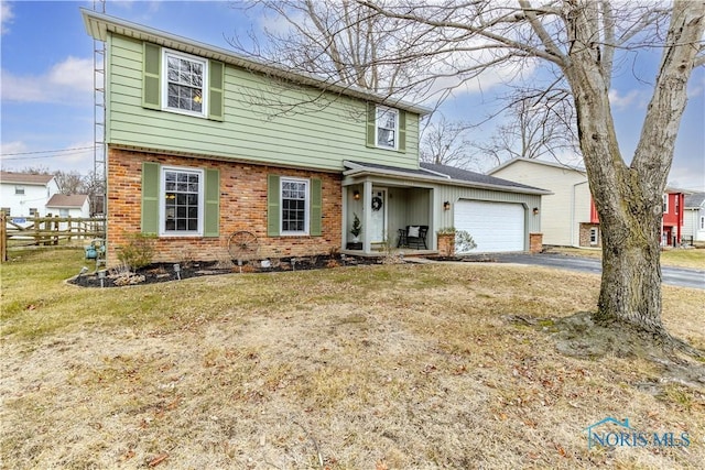 front facade with a garage and a front lawn