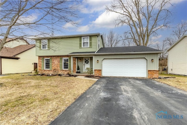 front facade with a garage and a front yard