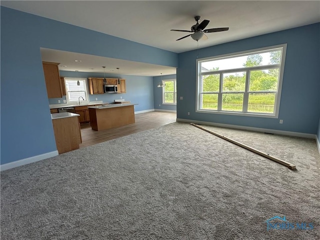 2016 Oakside, Toledo, OH 43615 - kitchen featuring open floor plan, brown cabinetry, appliances with stainless steel finishes, baseboards, and carpet flooring