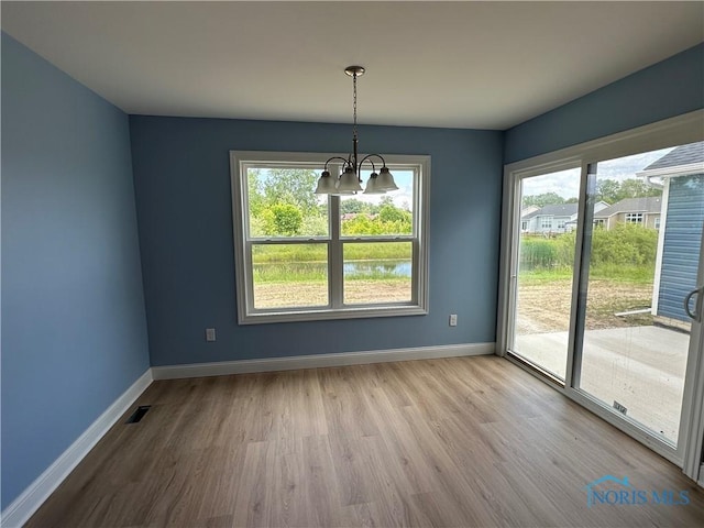 2016 Oakside, Toledo, OH 43615 - unfurnished dining area featuring a chandelier, baseboards, and wood finished floors