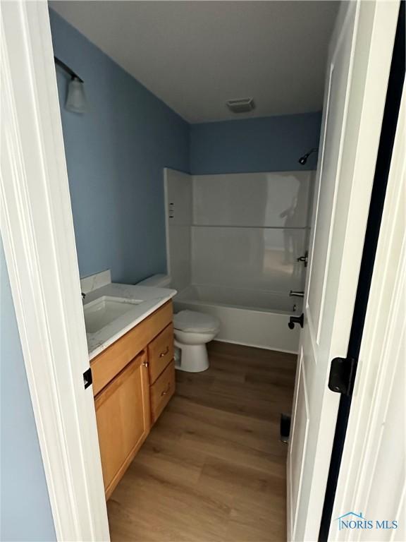 2016 Oakside, Toledo, OH 43615 - bathroom featuring vanity, wood finished floors, toilet, and shower / bath combination