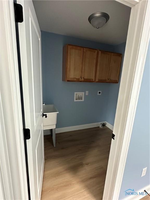 2016 Oakside, Toledo, OH 43615 - laundry room featuring light wood finished floors, washer hookup, cabinet space, baseboards, and hookup for an electric dryer