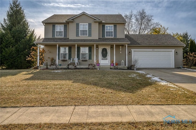 view of front of house featuring a porch, a garage, and a front yard