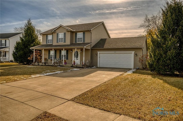 view of front facade with a garage, a lawn, and covered porch