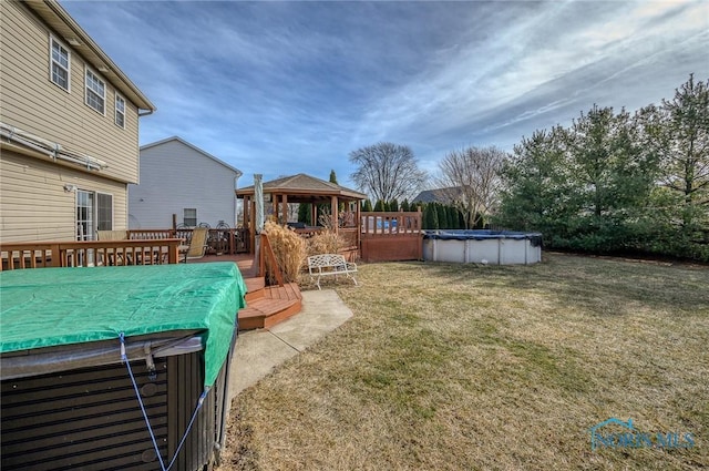 view of yard with a gazebo and a pool side deck