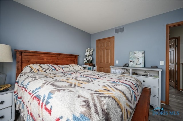 bedroom with dark wood-type flooring