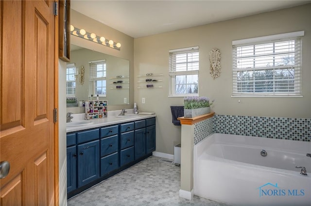 bathroom with vanity and a bath