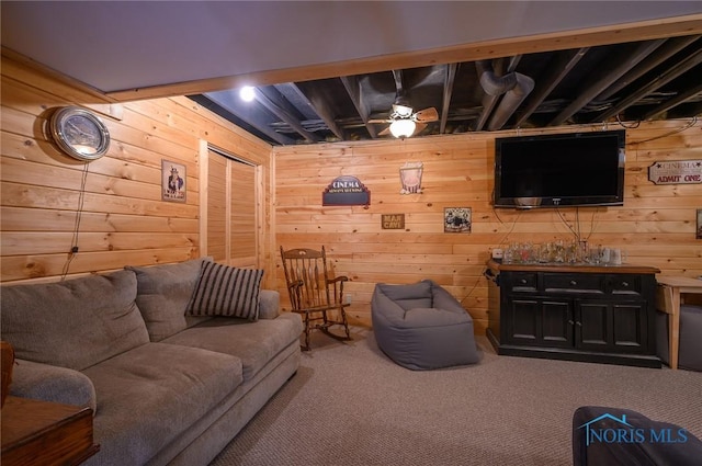 carpeted living room featuring wooden walls