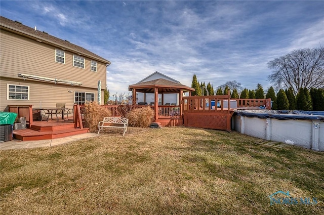 view of yard featuring a gazebo and a swimming pool side deck