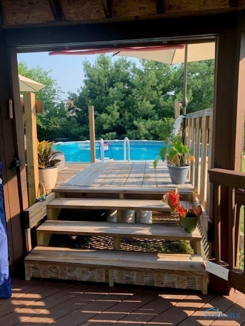 view of pool with a wooden deck