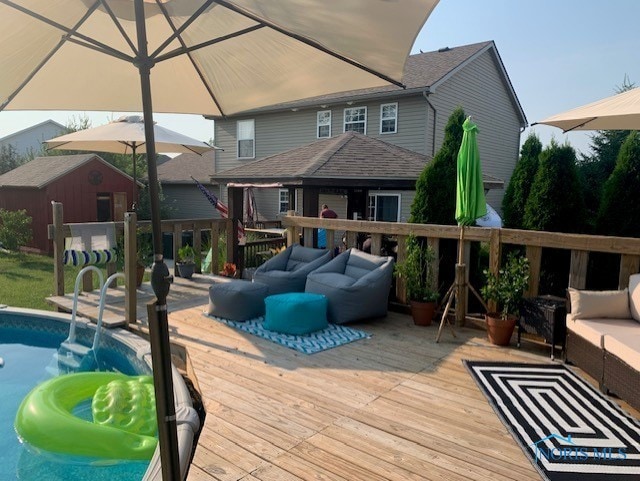 wooden terrace featuring outdoor lounge area and a shed