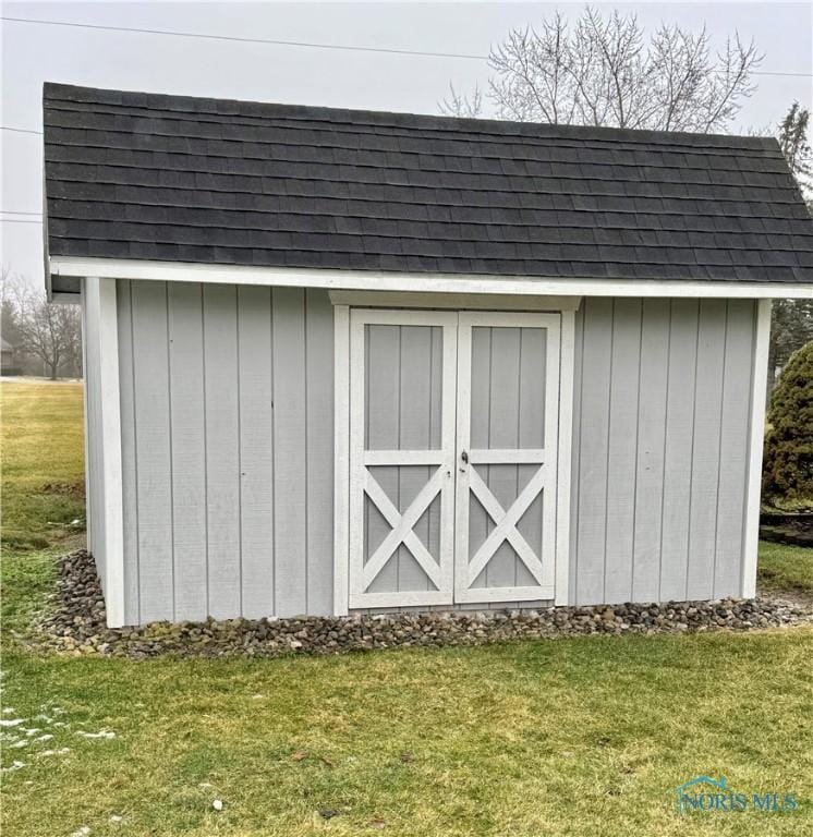 view of outbuilding with a lawn