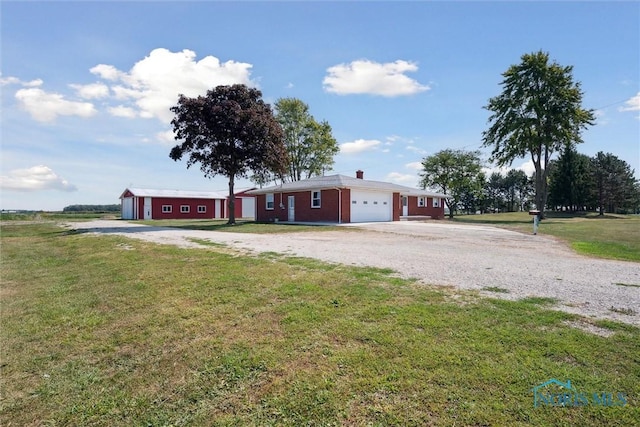 ranch-style home with a garage and a front yard