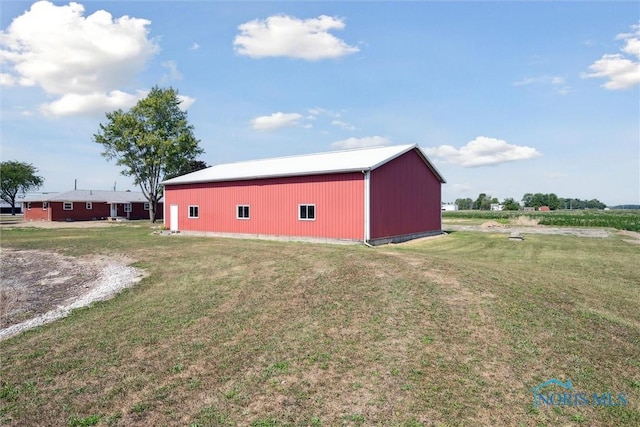 view of outbuilding featuring a yard