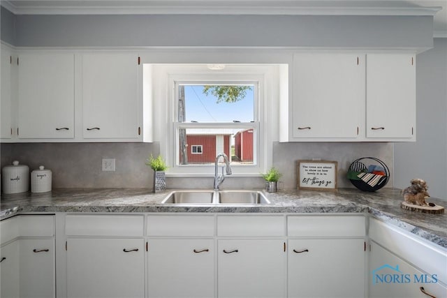 kitchen with white cabinetry and sink