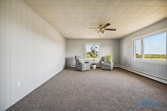 unfurnished room featuring a baseboard radiator, a healthy amount of sunlight, and carpet flooring