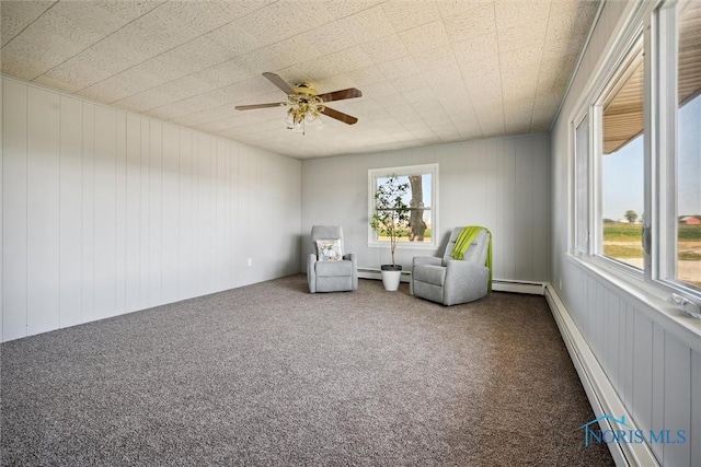 unfurnished room featuring a baseboard radiator, ceiling fan, and carpet flooring