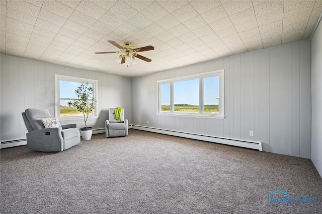 unfurnished room with a wealth of natural light, carpet, and baseboard heating