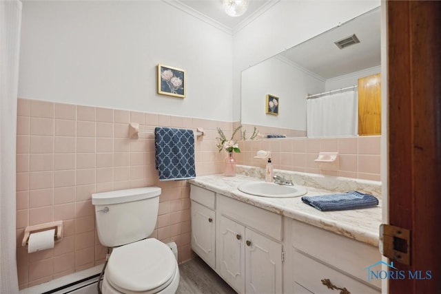 bathroom with crown molding, tile walls, vanity, a baseboard radiator, and toilet