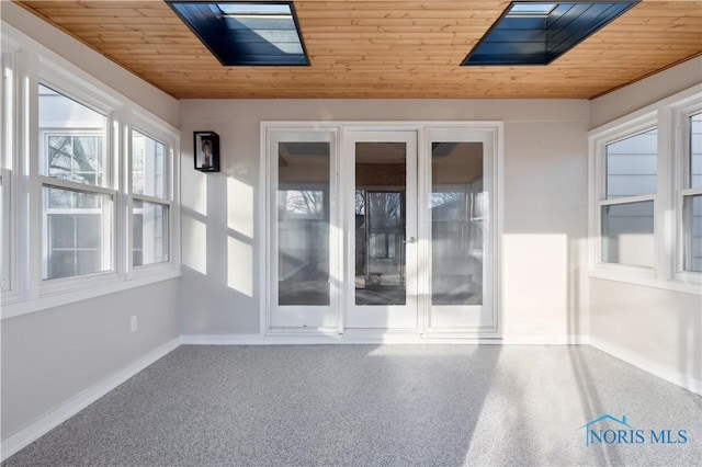 unfurnished sunroom featuring wood ceiling and lofted ceiling with skylight