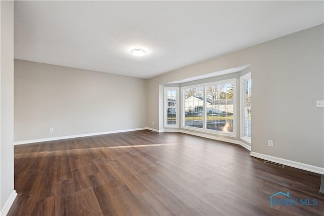 unfurnished room featuring dark hardwood / wood-style floors