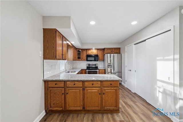 kitchen featuring stainless steel appliances, tasteful backsplash, sink, and hardwood / wood-style floors