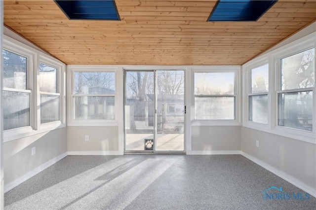 unfurnished sunroom featuring vaulted ceiling and wooden ceiling