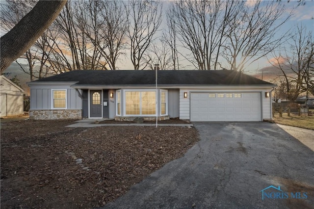 single story home featuring a garage