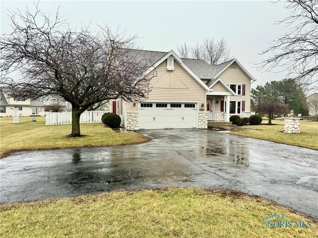 view of property featuring a garage and a front yard